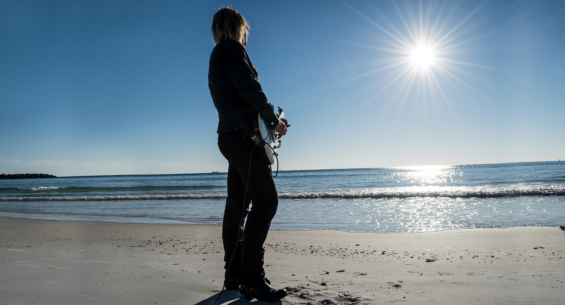 Pixabay guitarist on the beach | Outdoorsy RV Rental Marketplace