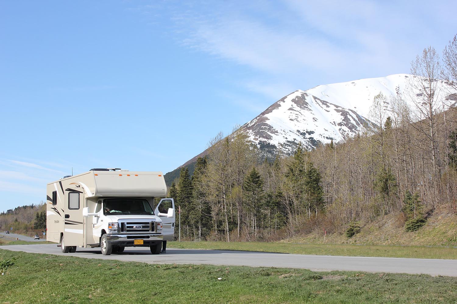 rv getting ready to drive next to snowy mountain
