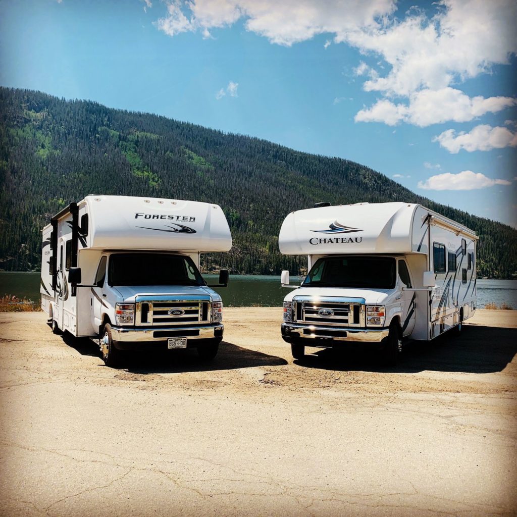 Two RVs against mountainside