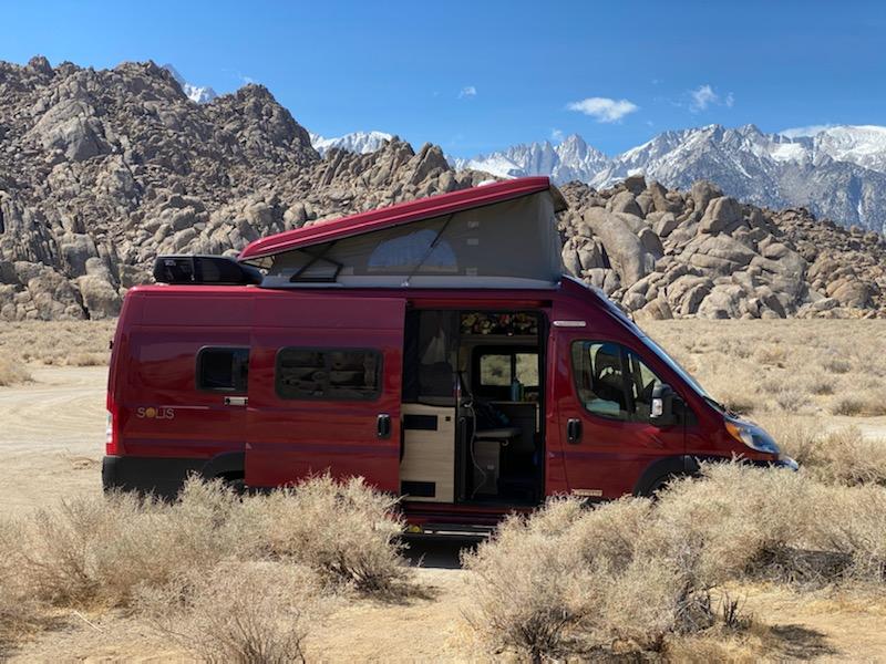 Red RV in a desert mountainside
