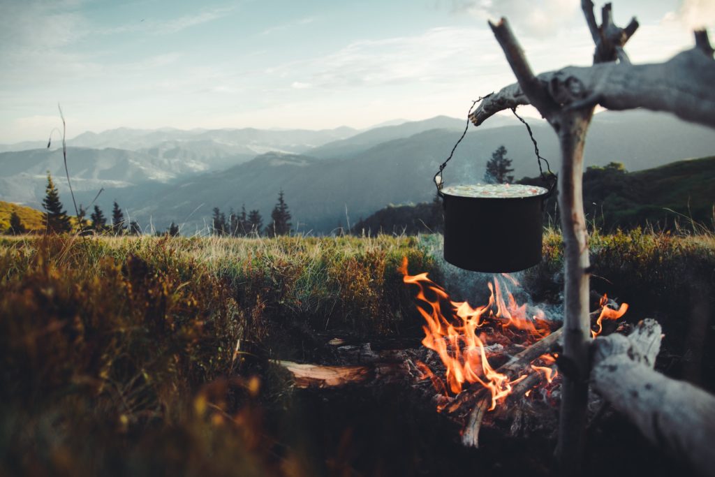 Dutch oven cooking with mountains in background
